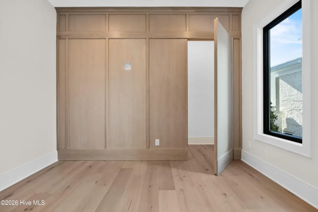 Full Height Natural Wood Accent Wall with Integrated Hidden Door
